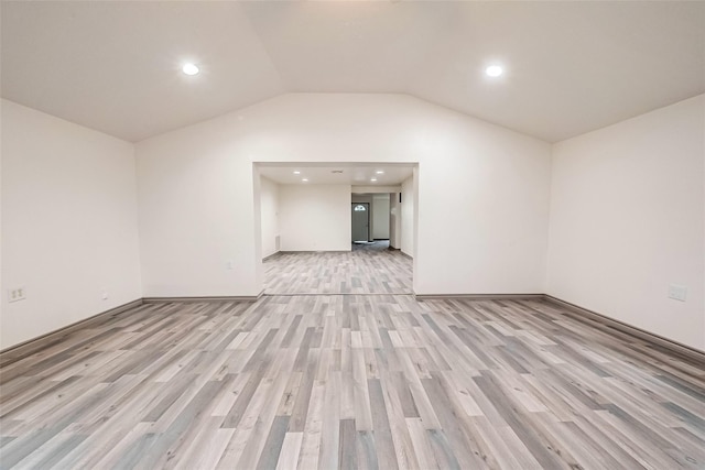 unfurnished living room featuring light hardwood / wood-style flooring and vaulted ceiling