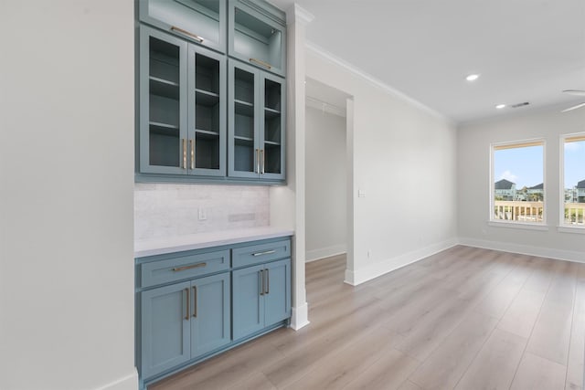 interior space featuring crown molding and light hardwood / wood-style flooring