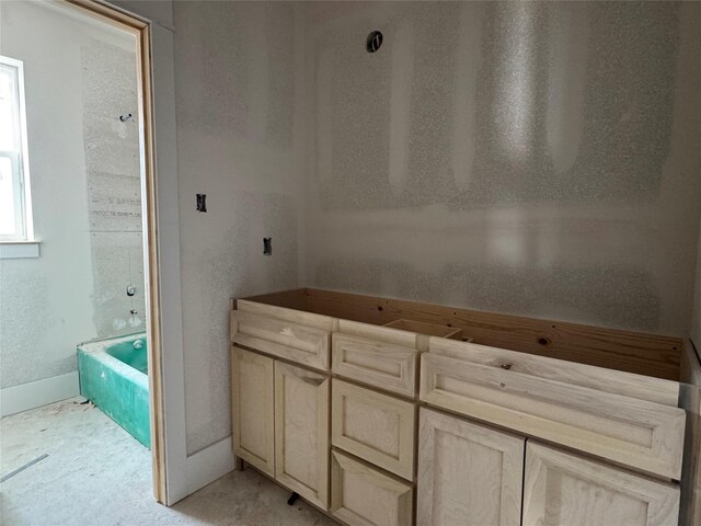 bathroom with a tub to relax in