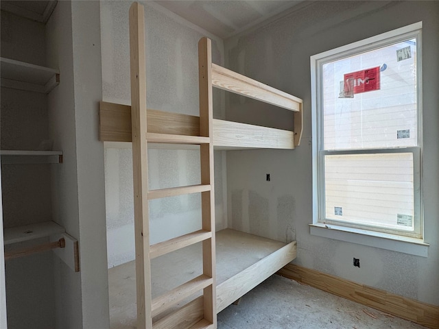 unfurnished bedroom featuring multiple windows