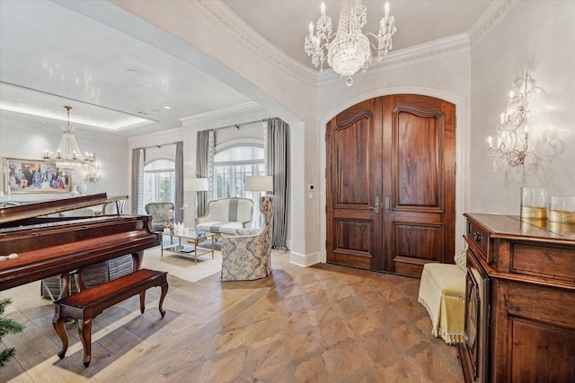 entrance foyer featuring crown molding and an inviting chandelier