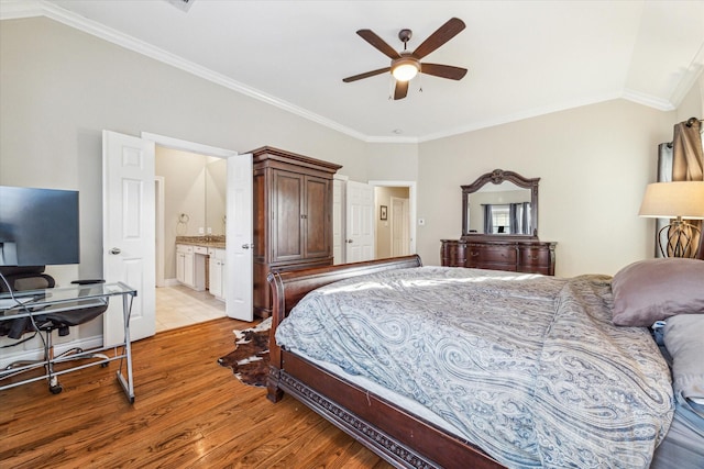 bedroom featuring connected bathroom, ceiling fan, ornamental molding, and light wood-type flooring