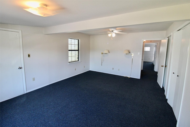 carpeted spare room with ceiling fan