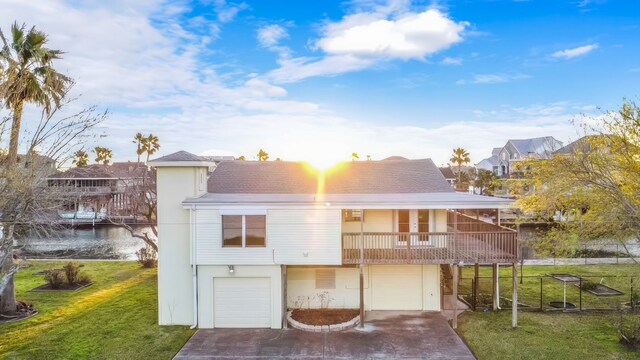 view of front facade featuring a balcony, a garage, and a front lawn