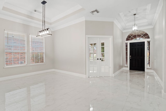 foyer with a tray ceiling, crown molding, and french doors