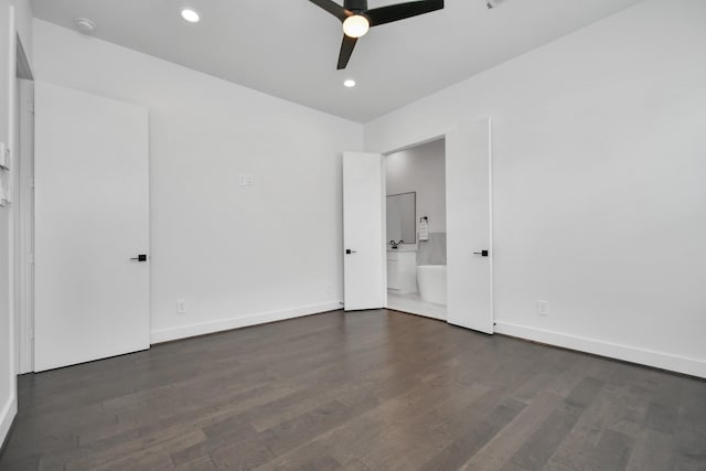 unfurnished bedroom with ensuite bath, ceiling fan, and dark hardwood / wood-style flooring