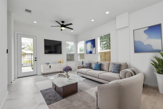 living room with ceiling fan and a healthy amount of sunlight