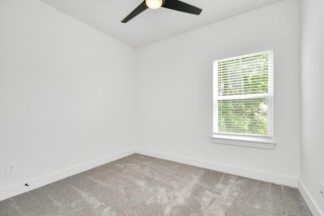 carpeted empty room featuring ceiling fan