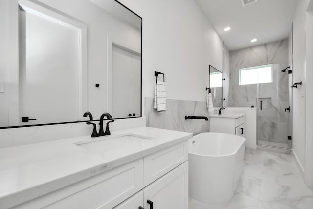 bathroom with tile walls, shower with separate bathtub, and vanity