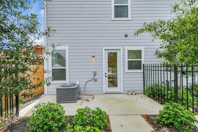 entrance to property featuring central air condition unit and a patio area