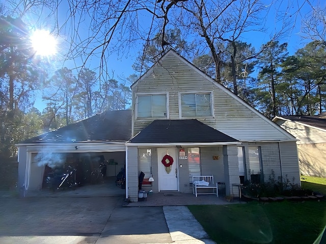 bungalow featuring covered porch and a garage