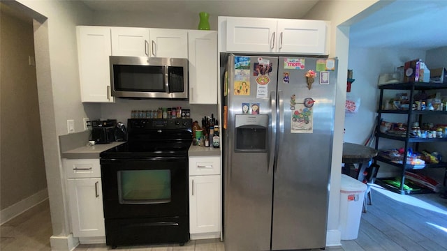 kitchen with white cabinets and appliances with stainless steel finishes