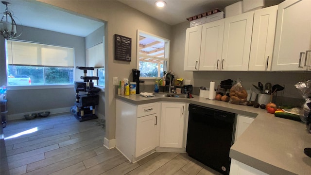 kitchen with sink, dishwasher, and white cabinetry