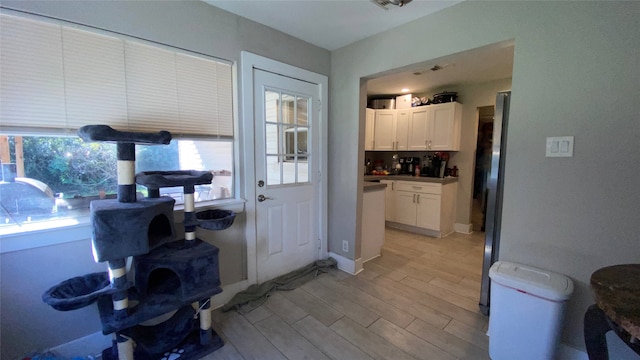 doorway to outside with light hardwood / wood-style floors and a healthy amount of sunlight