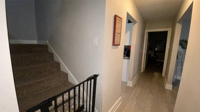 corridor with hardwood / wood-style floors