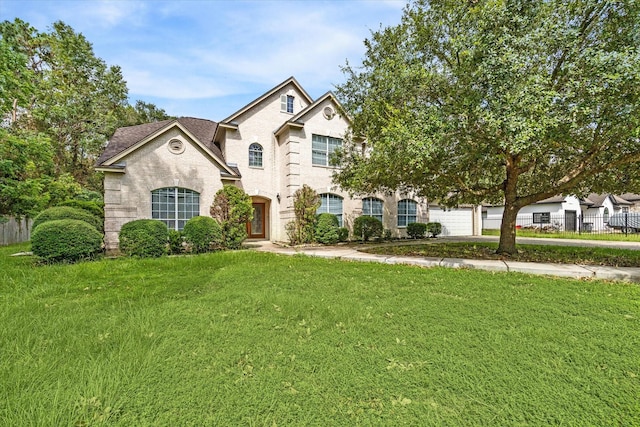 view of front of home with a garage and a front lawn