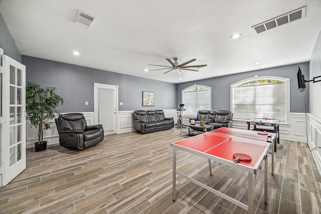 game room with french doors and ceiling fan