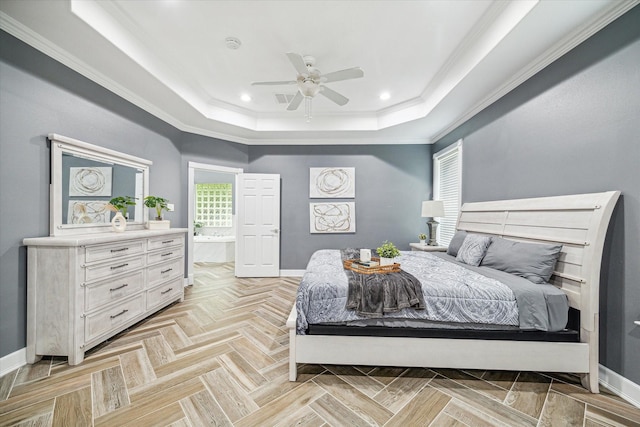 bedroom with light parquet floors, a raised ceiling, ceiling fan, ensuite bath, and crown molding