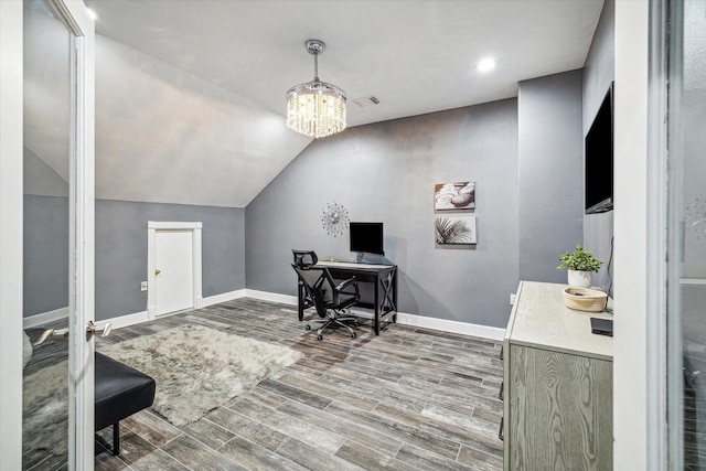 office area featuring wood-type flooring, an inviting chandelier, and vaulted ceiling