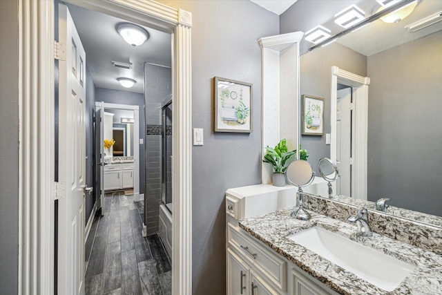 bathroom featuring vanity and shower / bath combination with glass door