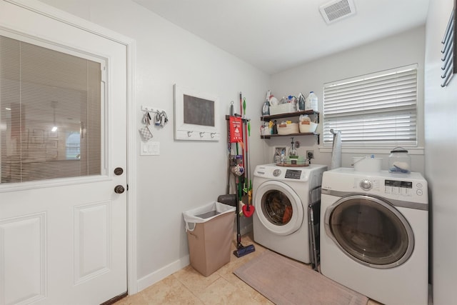 laundry room featuring washer and dryer and light tile patterned flooring