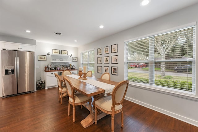 dining room with a healthy amount of sunlight and dark wood-type flooring