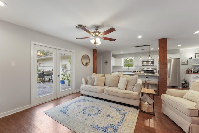 living room featuring dark hardwood / wood-style flooring, french doors, ceiling fan, and a wealth of natural light