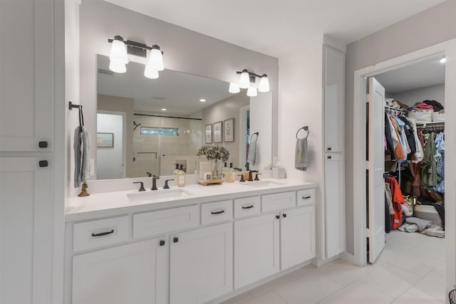 bathroom featuring vanity, tile patterned floors, and a shower with shower door