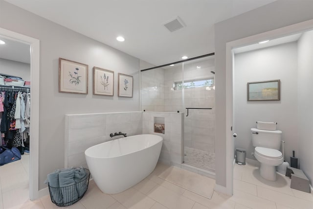 bathroom with toilet, tile patterned floors, and independent shower and bath