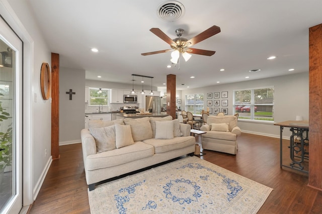 living room with ceiling fan, dark hardwood / wood-style flooring, and sink