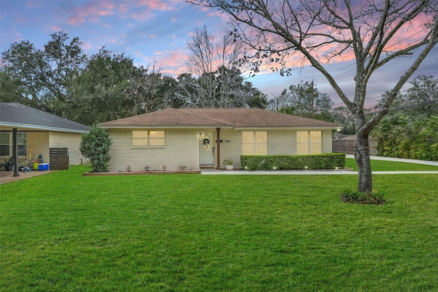 single story home featuring a yard