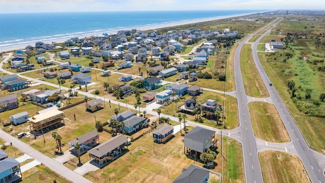 drone / aerial view with a beach view and a water view