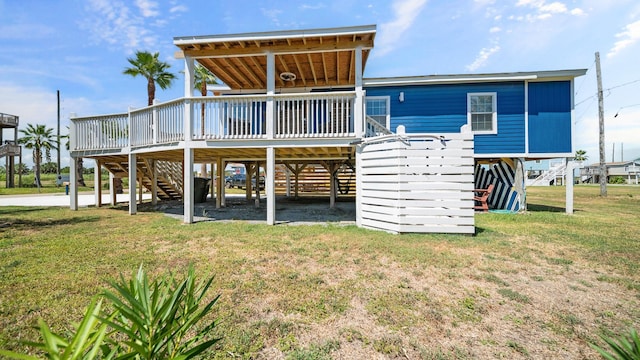 back of property with a yard and a wooden deck