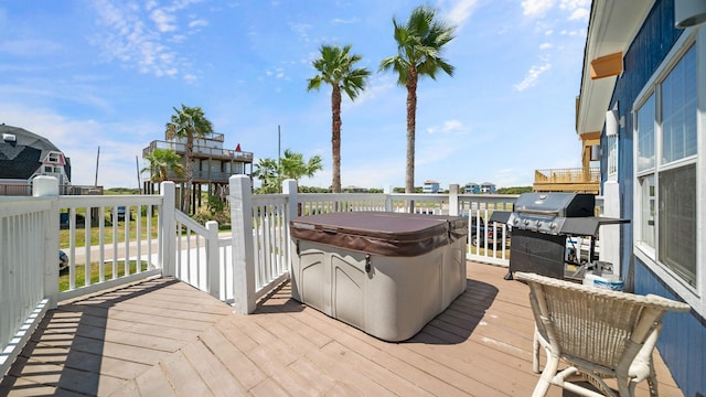 wooden deck with a hot tub and a grill