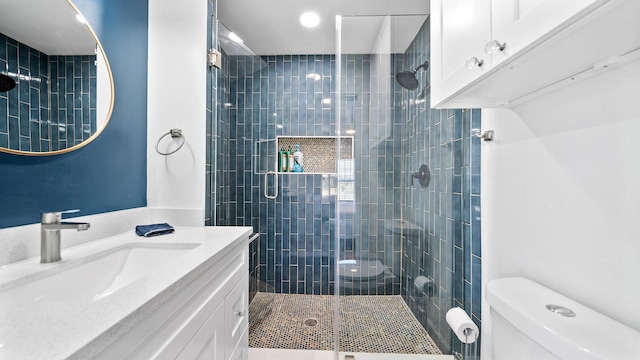 bathroom featuring walk in shower, vanity, and toilet