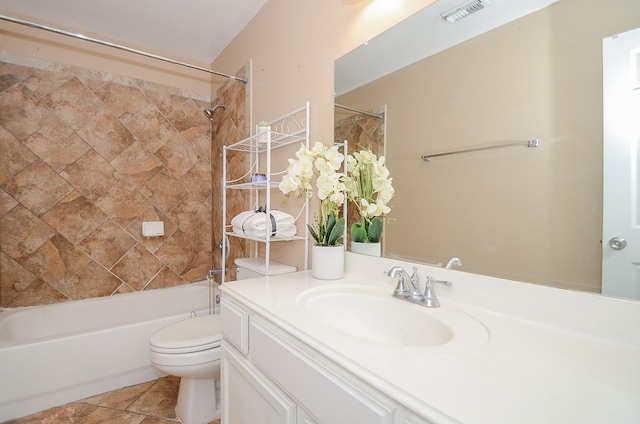 full bathroom featuring toilet, tiled shower / bath, and vanity