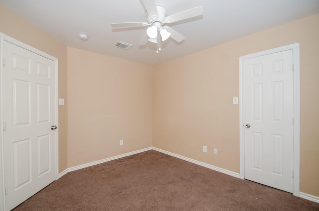 carpeted spare room featuring ceiling fan