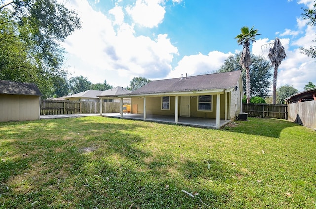 rear view of property with a patio and a yard