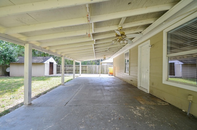 view of patio / terrace featuring ceiling fan and a shed