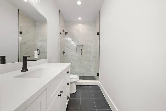 bathroom featuring toilet, vanity, tile patterned floors, and walk in shower