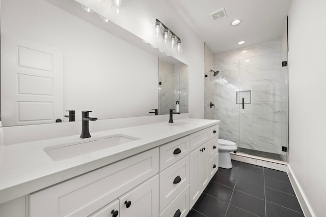 bathroom with toilet, vanity, tile patterned floors, and a shower with shower door