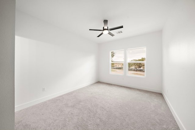 spare room featuring ceiling fan and carpet