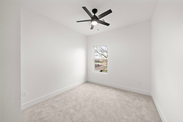 unfurnished room with light colored carpet and ceiling fan