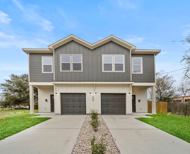 view of front of property with a front lawn and a garage