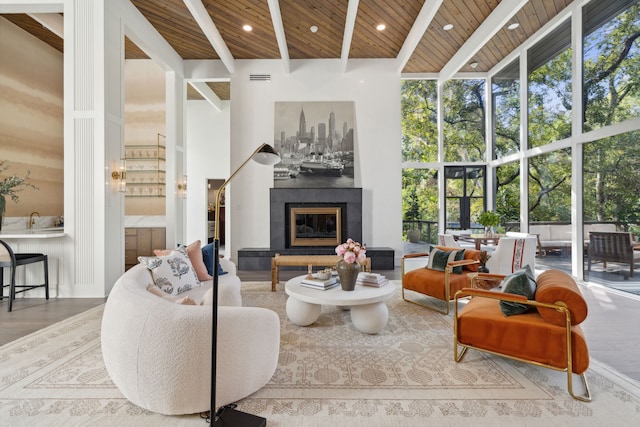 living room featuring a towering ceiling, a tiled fireplace, hardwood / wood-style floors, floor to ceiling windows, and wood ceiling