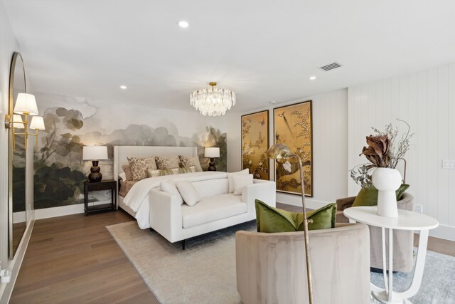 bedroom featuring a notable chandelier and hardwood / wood-style flooring