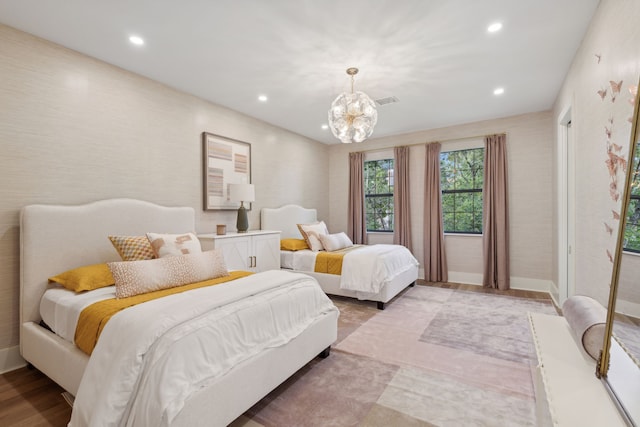 bedroom featuring light hardwood / wood-style floors and an inviting chandelier