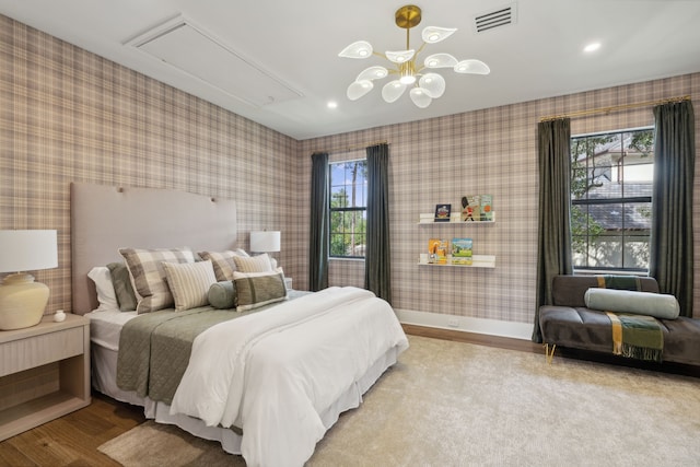 bedroom featuring light hardwood / wood-style floors and a chandelier