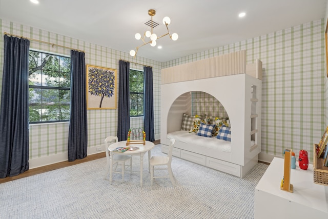 bedroom featuring a notable chandelier and hardwood / wood-style floors