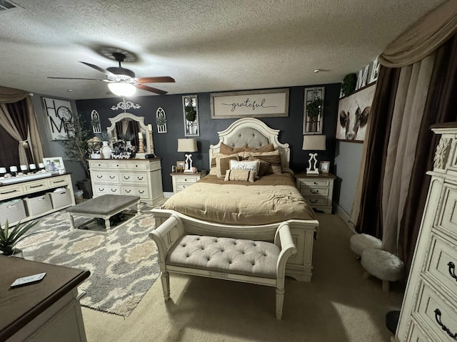 carpeted bedroom featuring a textured ceiling and ceiling fan